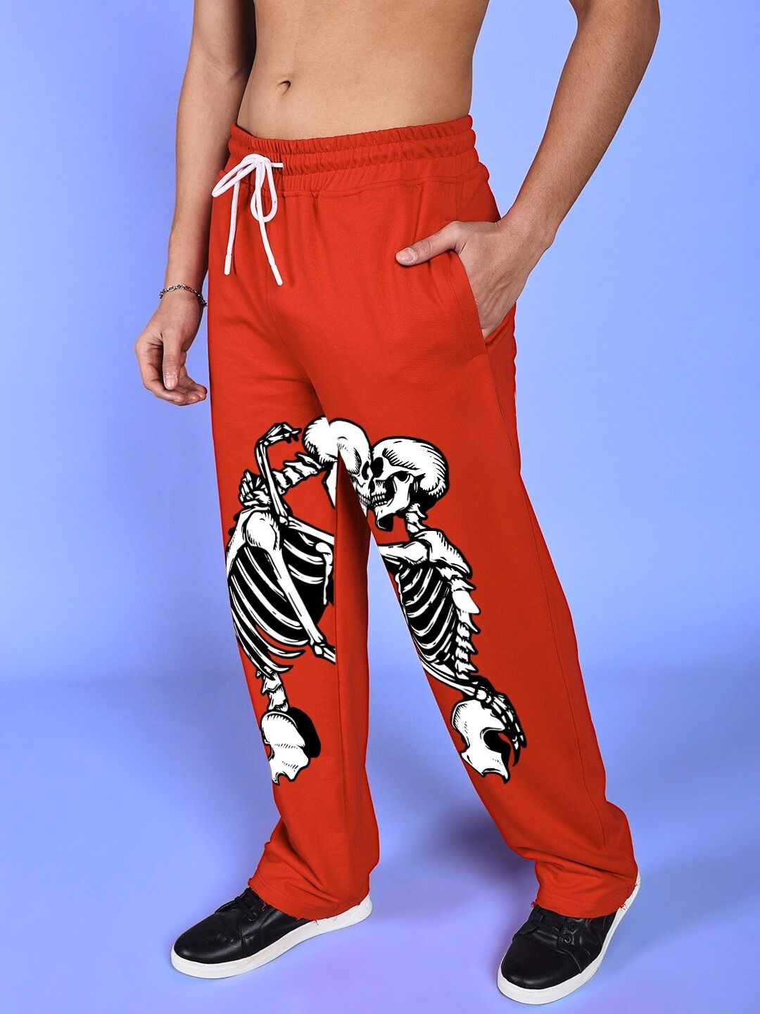 Person wearing SKELETONS LOVE RELAXED FIT JOGGER RED with skeleton design, showcasing casual comfort and style.