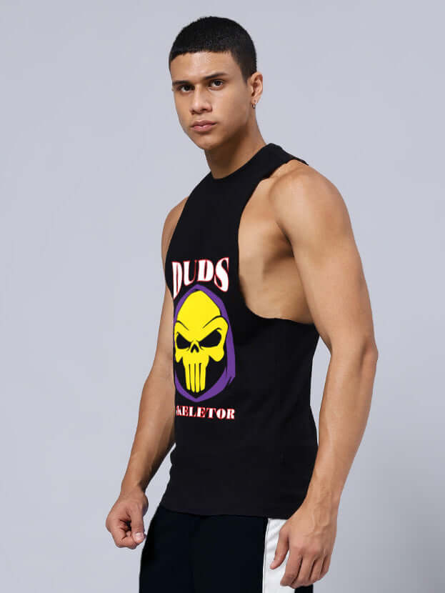 Model wearing SKELETOR PRINTED GYM T-SHIRT BLACK with skull design and sleeveless cut, ideal for workouts and custom fit available.