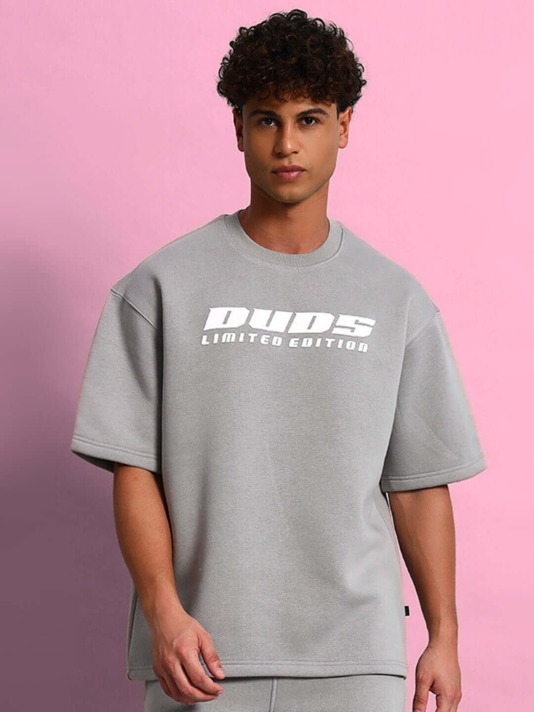 Model wearing SKODA COTTON FLEECE CO-ORD GREY set against a pink background.