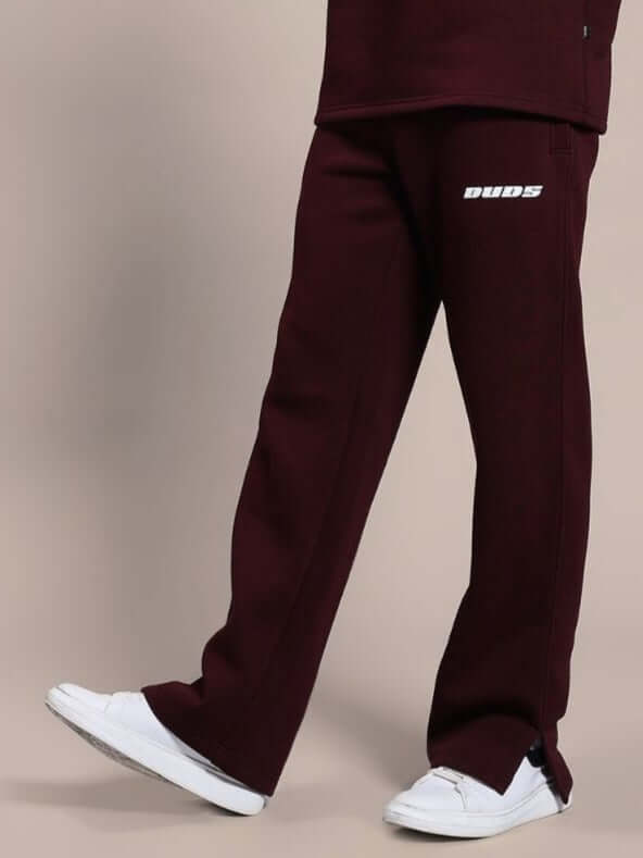 Person wearing SKODA COTTON FLEECE JOGGER MAROON with white sneakers.