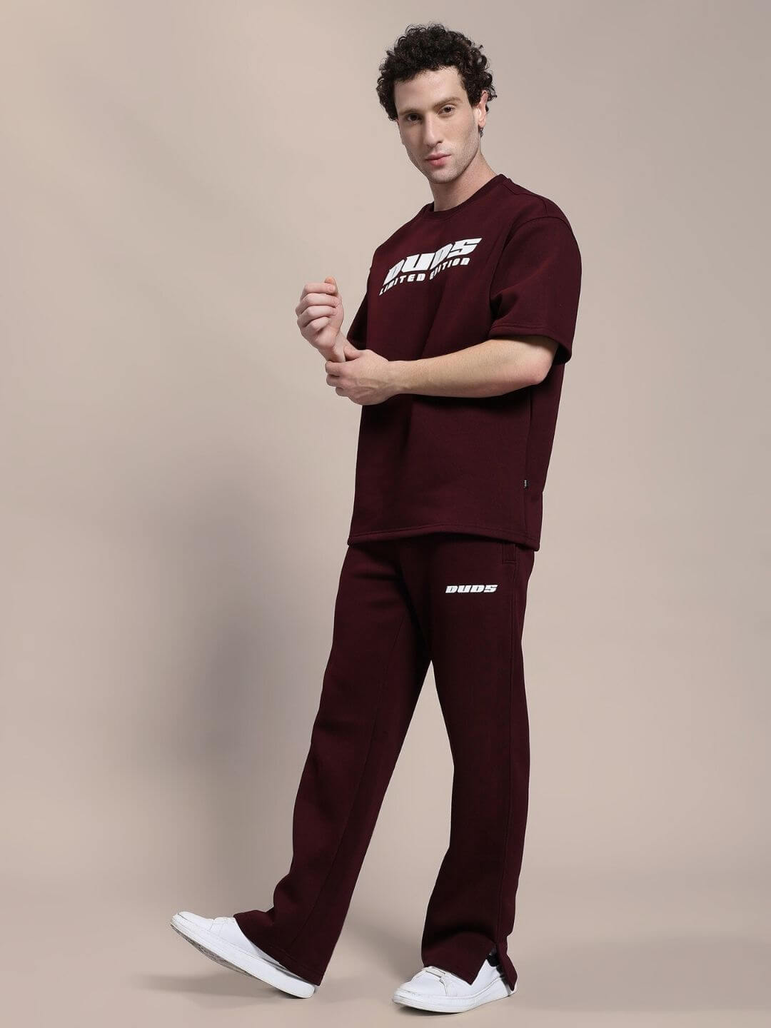 Model wearing SKODA FLEECE CO-ORD SET MAROON, featuring a matching fleece hoodie and joggers, showcasing cozy and bold style.