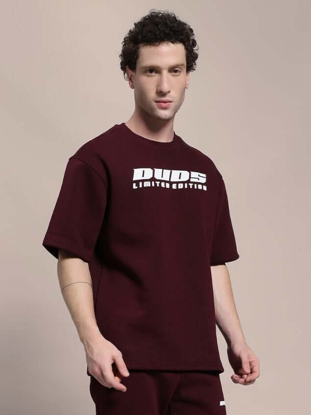 Model wearing SKODA FLEECE OVERSIZED T-SHIRT MAROON, showcasing casual and comfortable style.