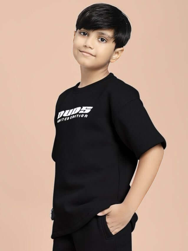 Child wearing black SKODA FLEECE T-SHIRT FOR BOYS AND GIRLS BLACK, showcasing stylish and comfortable design for everyday wear.
