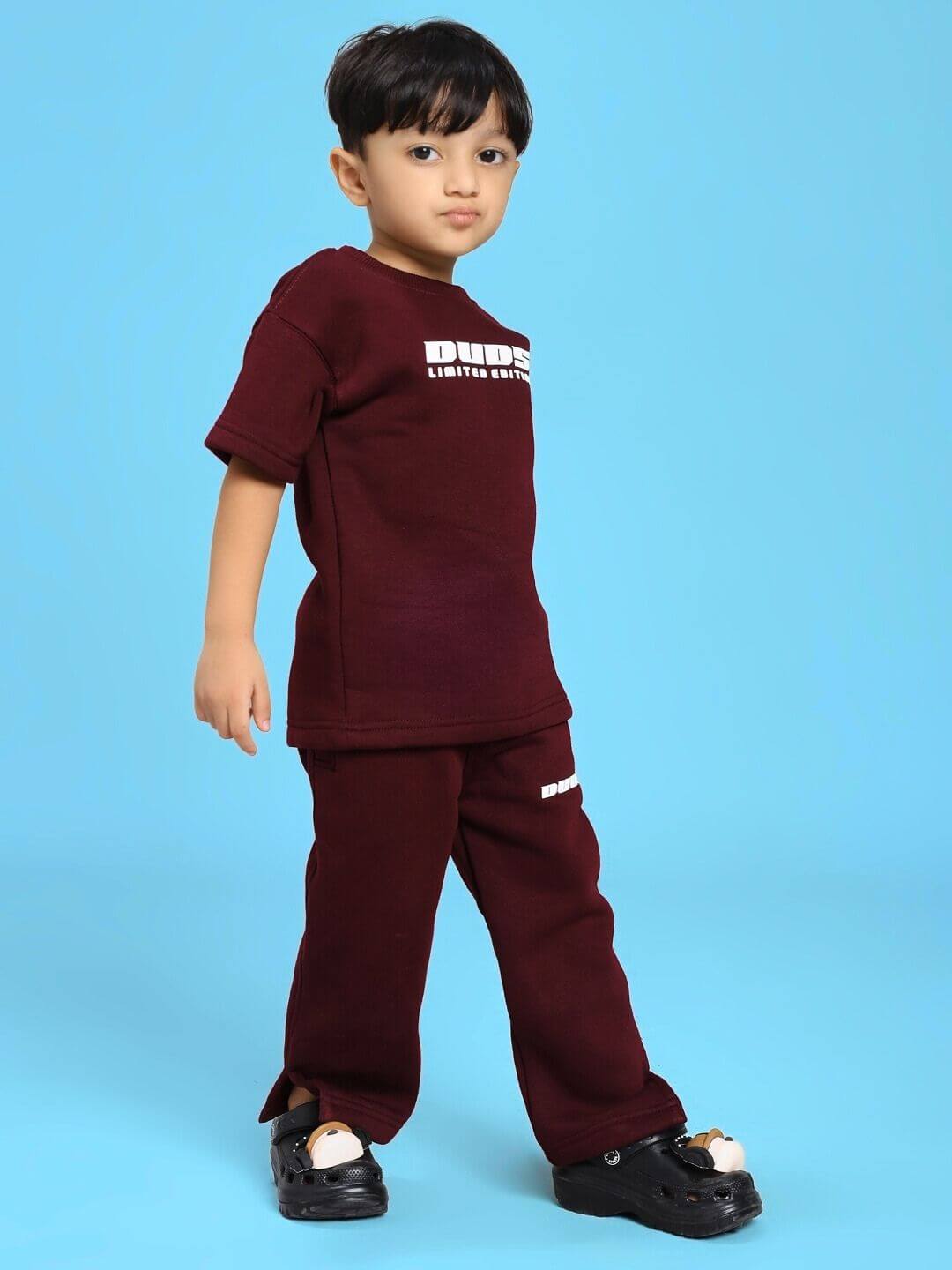 SKODA FLEECE T-SHIRT FOR BOYS AND GIRLS MAROON worn by a child on a blue background