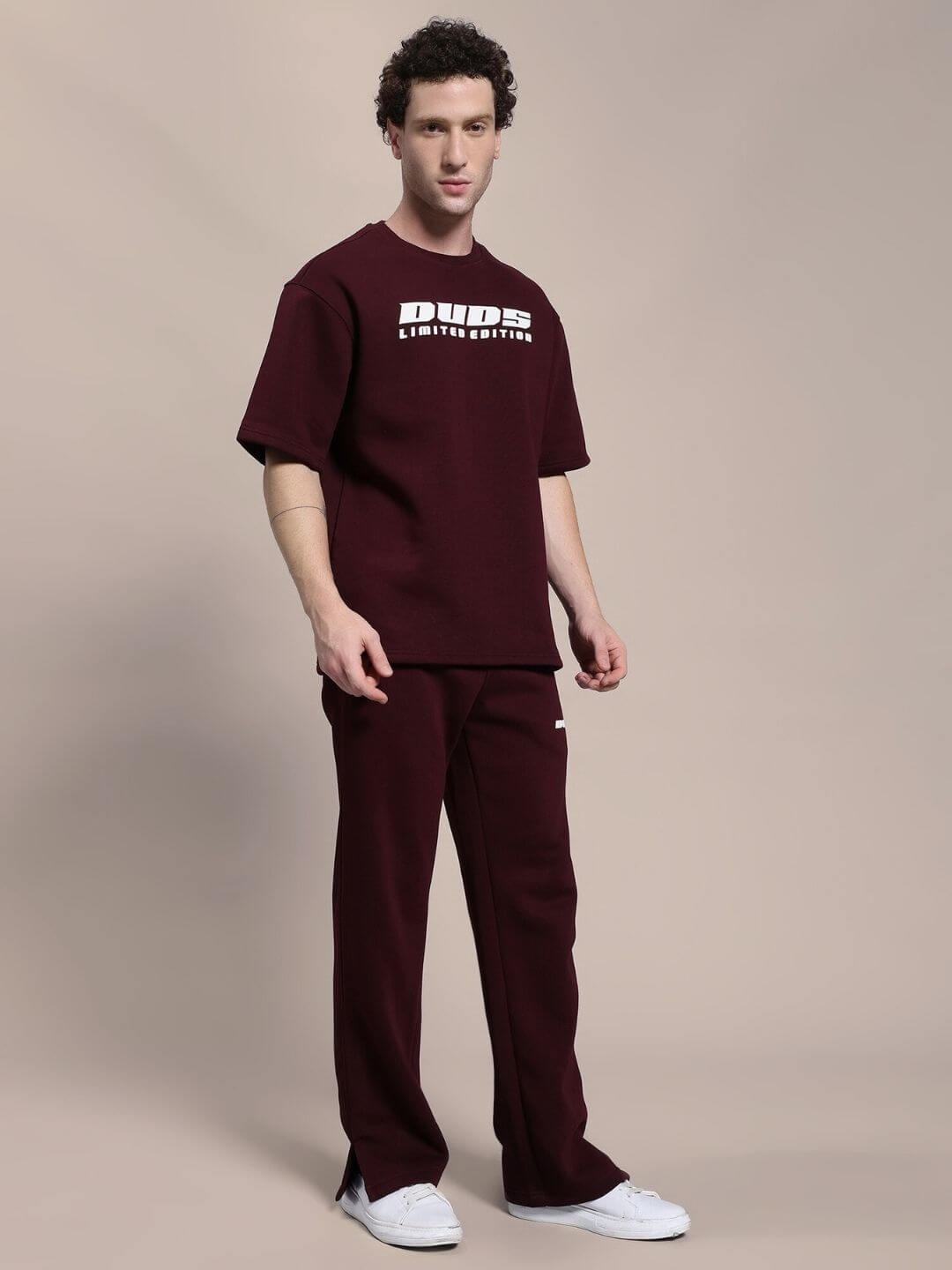 Man wearing SKODA COTTON FLEECE JOGGER MAROON standing, showcasing casual comfort and style.