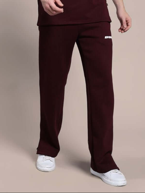 SKODA COTTON FLEECE JOGGER MAROON - comfort-focused, premium joggers in rich maroon color, shown on person with white sneakers.