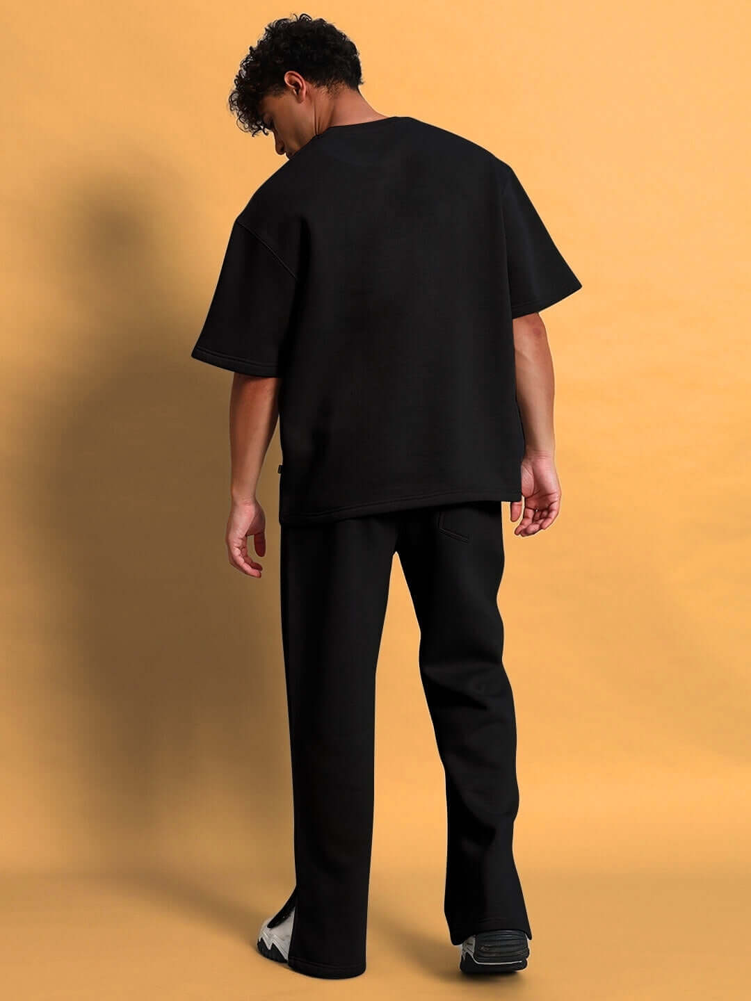 Model wearing WEARDUDS SKODA FLEECE CO-ORD BLACK, back view, customizable sizing available, made to order.