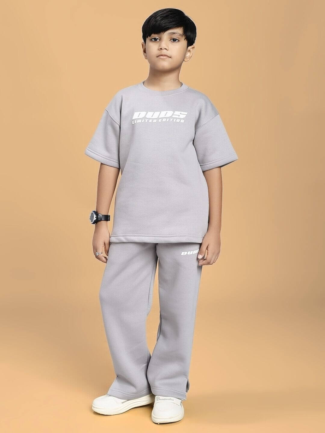 Child wearing SKODA FLEECE JOGGER FOR BOYS AND GIRLS GREY with matching top, showcasing casual style and comfort.