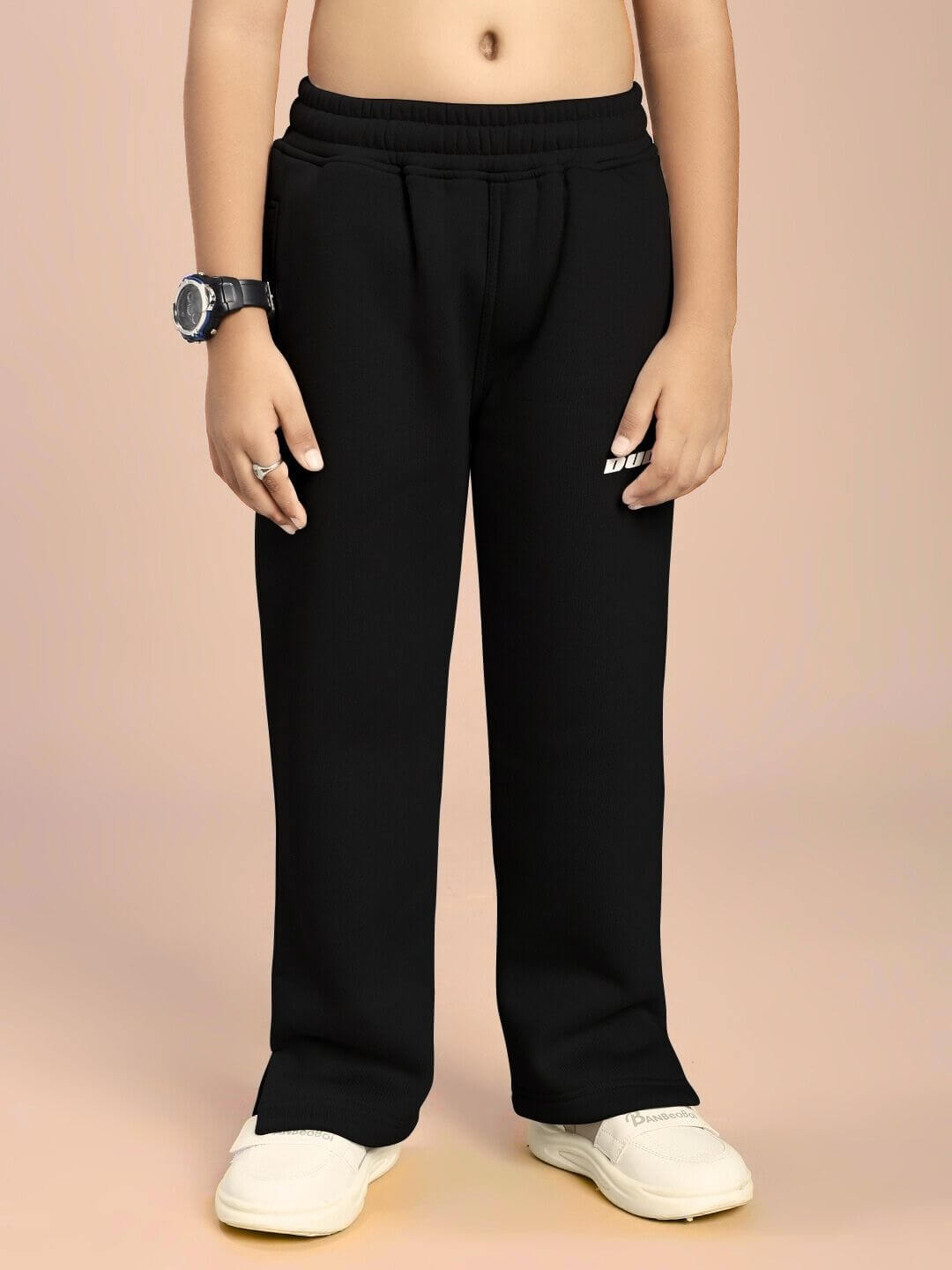 Child wearing SKODA FLEECE CO-ORD FOR BOYS AND GIRLS BLACK trousers, showing comfort and style in sleek design.