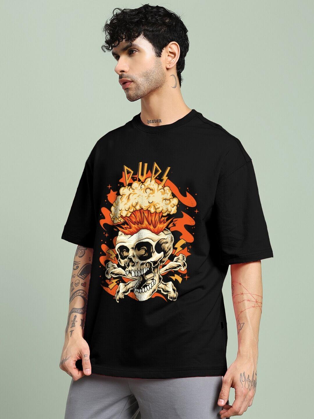 Men's model wearing Skull Blast Fire Print Oversized T-Shirt Black with skull and fire graphics, contemporary street fashion.