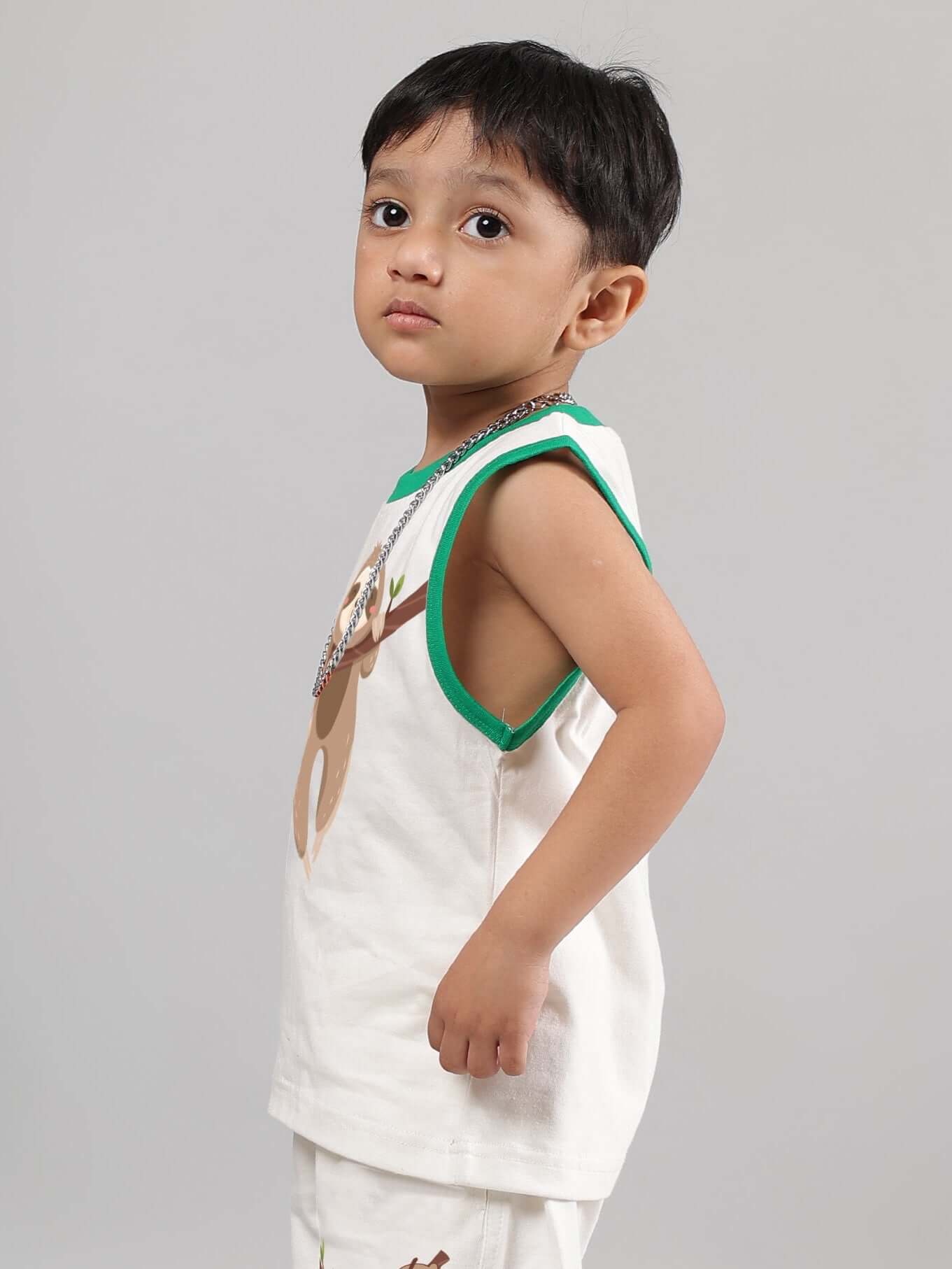 Child wearing off-white sloth t-shirt for boys and girls, side view, with green trim. Perfect for custom orders, made by DUDS.