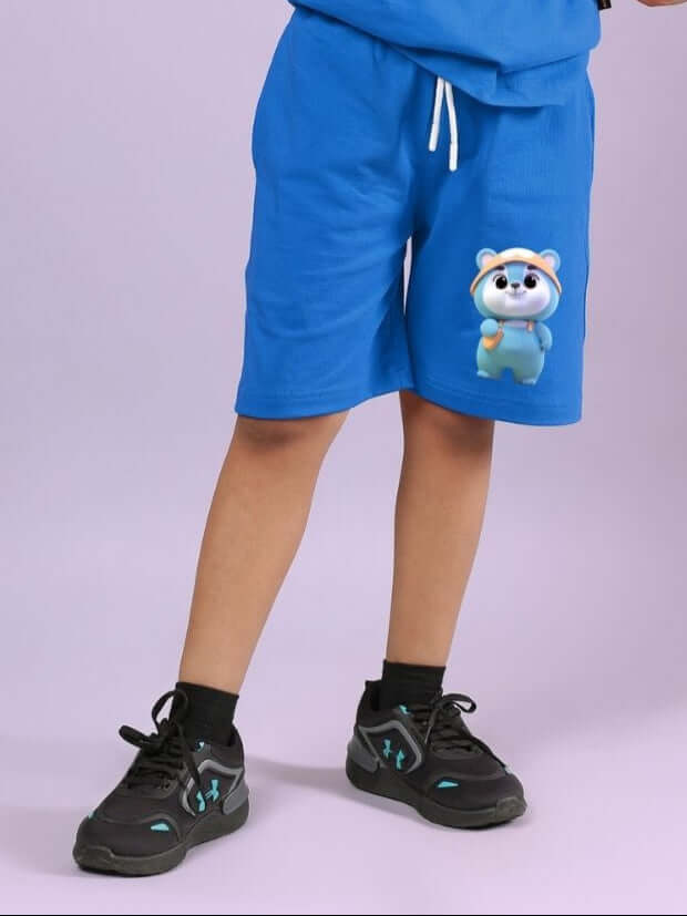 Child wearing blue unisex Smiley Bear shorts with elastic waistband, perfect for active days and casual comfort.
