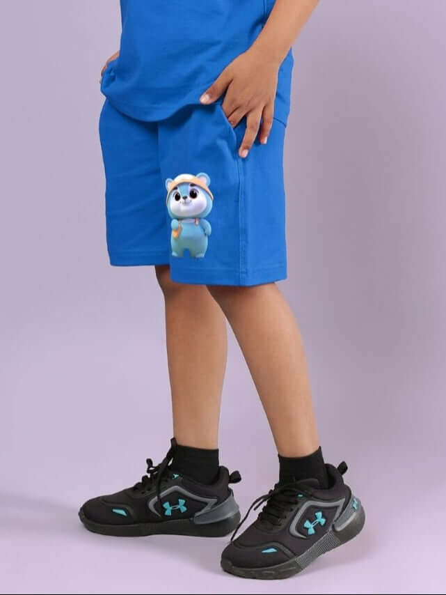 Child wearing blue Smiley Bear shorts with elastic waistband, showcasing playful design and comfortable fit, perfect for active kids.