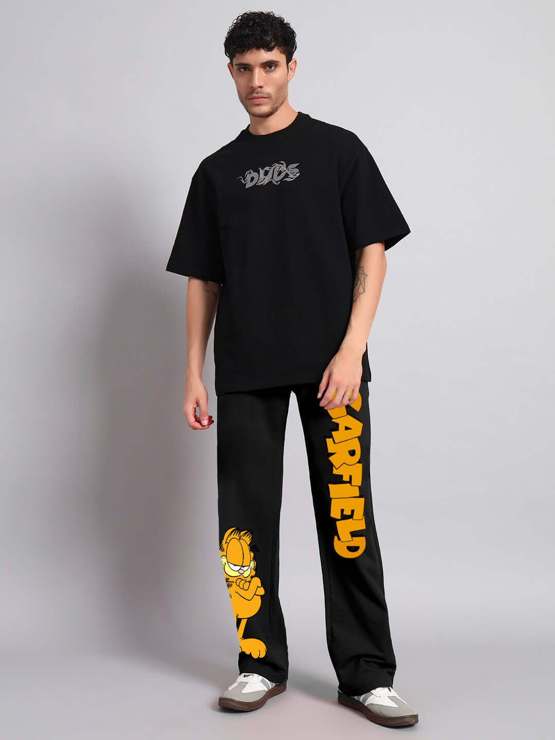 Model wearing SMUG GARFIELD Relaxed Fit Jogger in black with Garfield graphic, designed by DUDS. Ideal for custom or standard fit purchase.