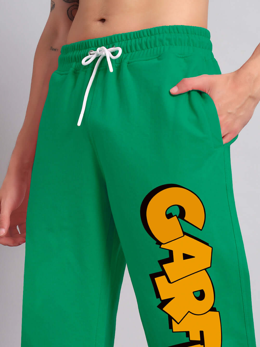 Green relaxed fit jogger with bold lettering, featuring a comfortable drawstring waistband and side pockets, perfect for casual wear.