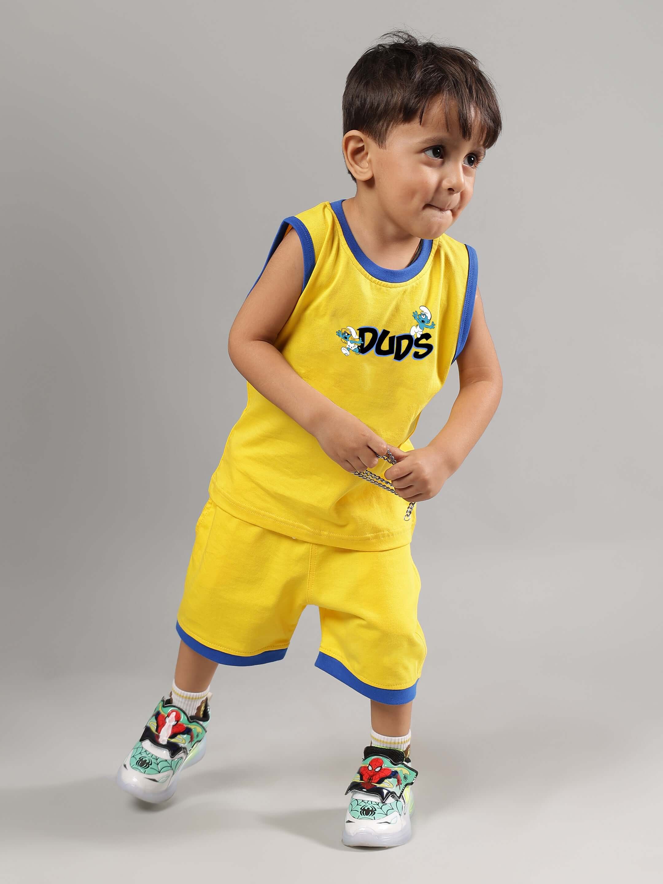 Child wearing SMURFS HOME CO-ORD FOR BOYS GIRLS YELLOW, featuring vibrant yellow t-shirt and shorts set for playful, comfortable look.