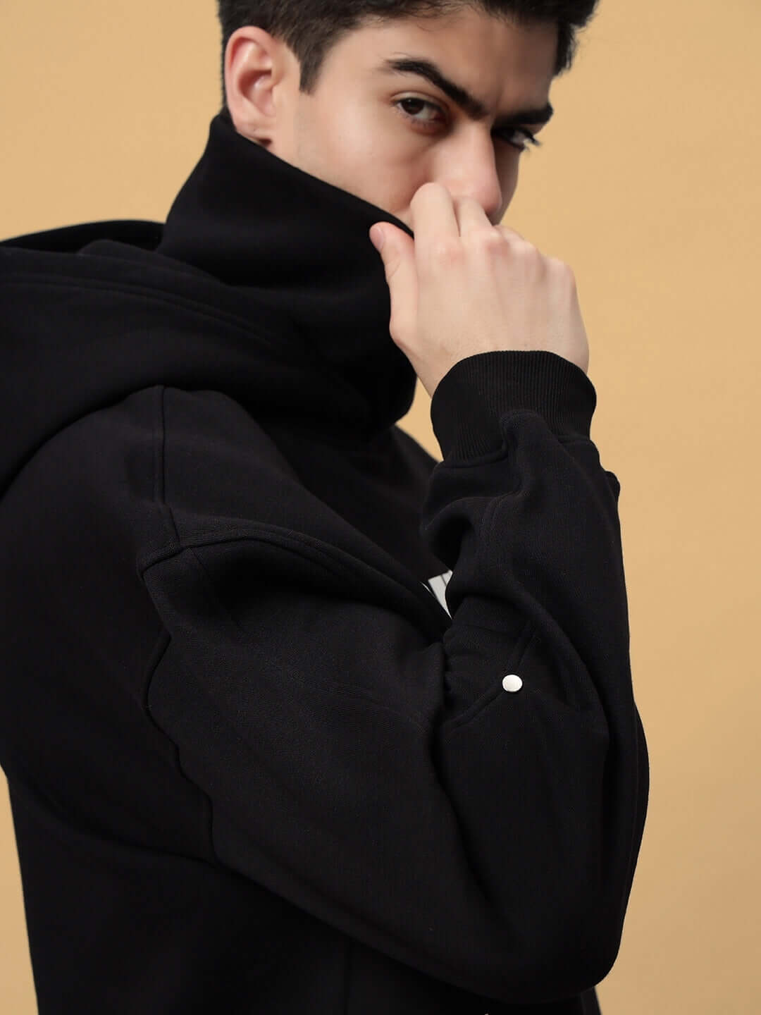 Man wearing SNIPPER COTTON FLEECE HOODIE BLACK showcasing streetwear style with comfort and modern fit.