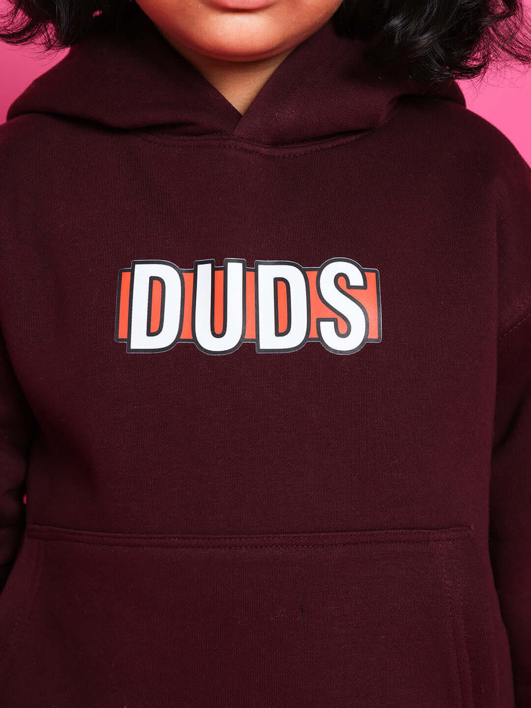 Close-up of a child wearing a wine-colored SNOOPY CO-ORD FOR BOYS GIRLS WINE sweatshirt with "DUDS" printed on the front.