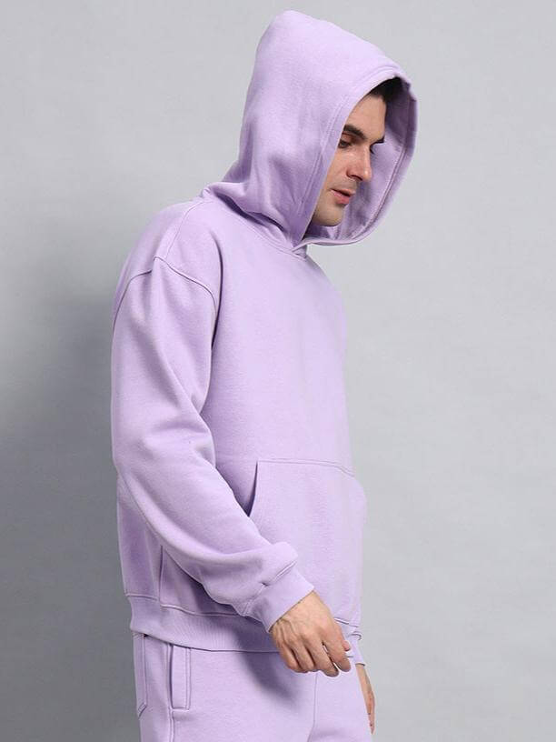 Model wearing solid oversized hoodie in lavender color.