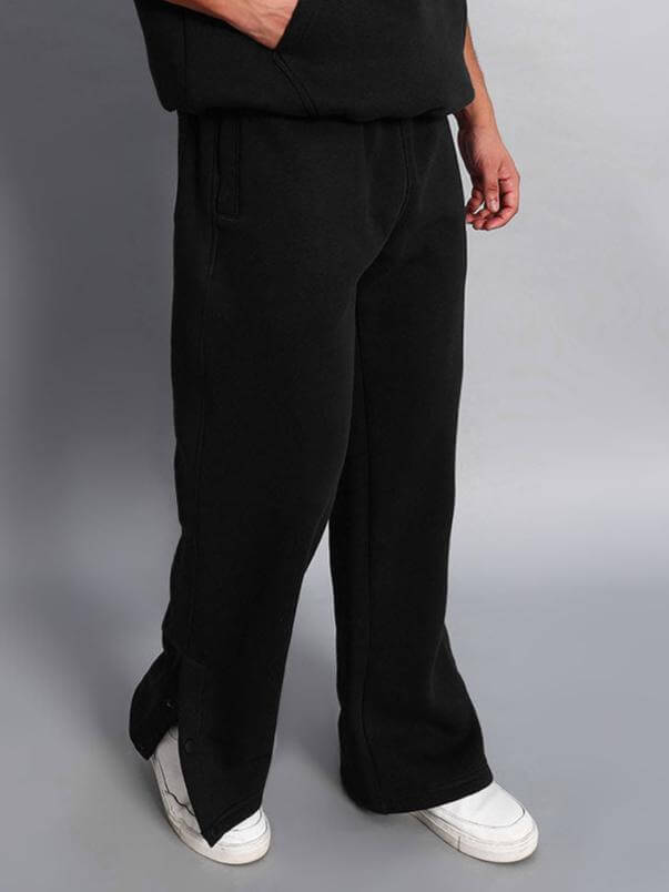 Model wearing WEARDUDS SOOTY FLEECE PANT BLACK, showcasing comfort and style in soft black fleece pants with white sneakers.