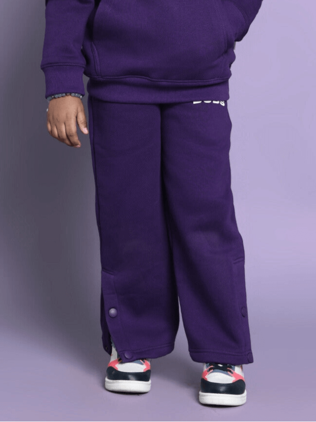 Child wearing purple Sooty fleece pants, suitable for boys and girls.