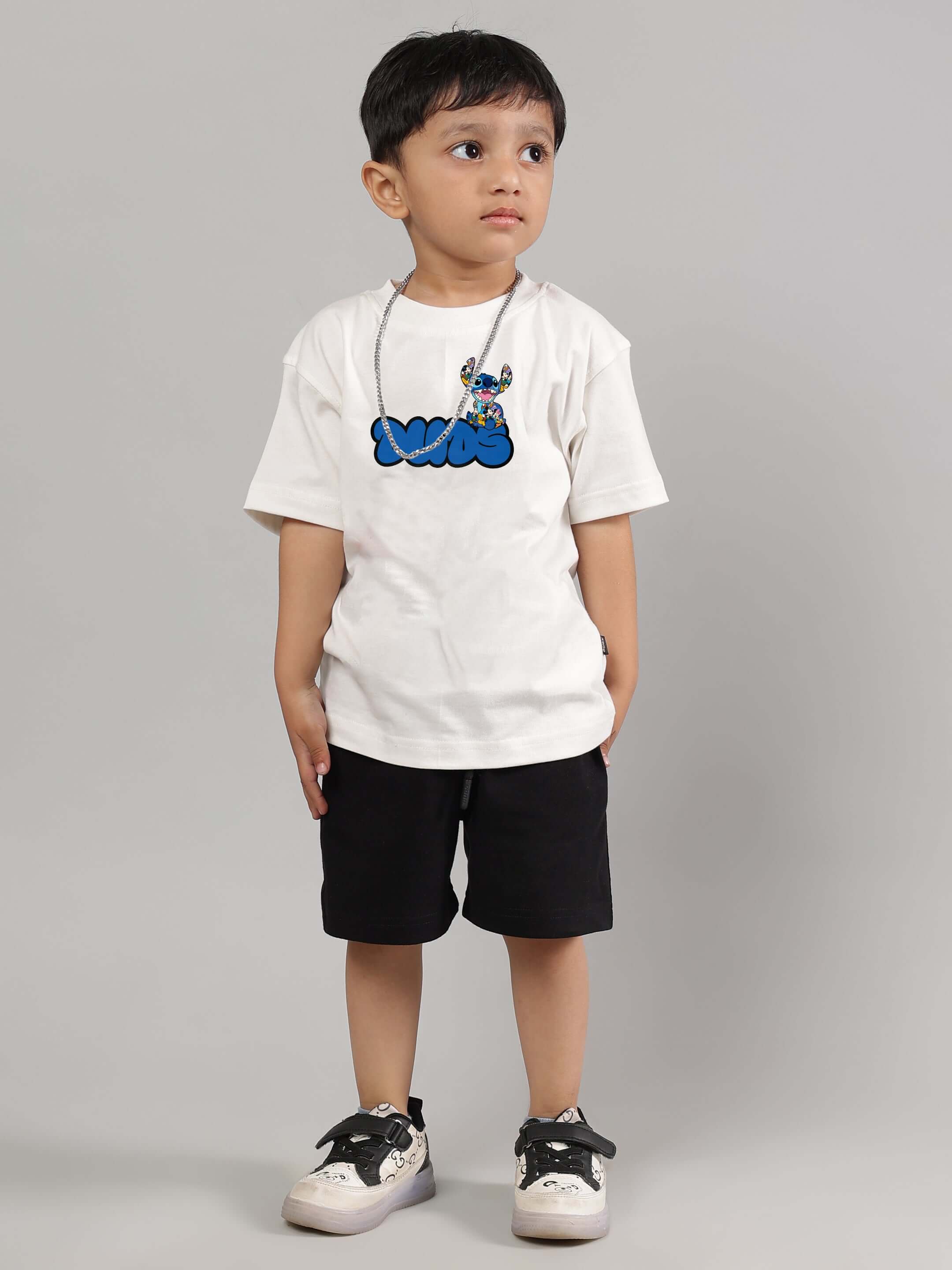 Young boy wearing SORE SUMMER CO-ORD FOR BOYS GIRLS OFF WHITE-BLACK, featuring a graphic tee and shorts, perfect for stylish summer wear.