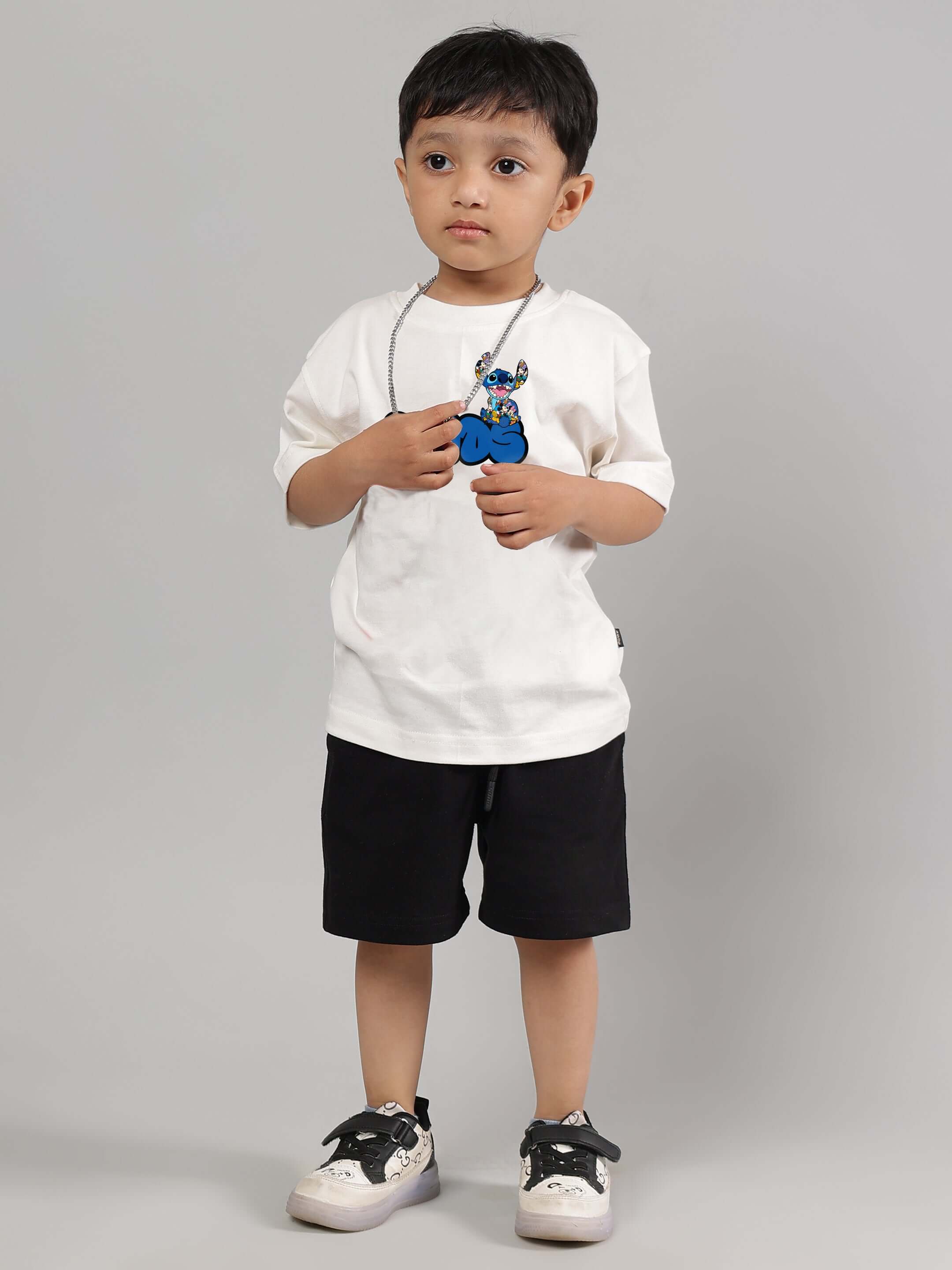 Child wearing SORE SUMMER CO-ORD FOR BOYS GIRLS OFF WHITE-BLACK outfit, featuring comfortable cotton fabric in off-white and black colors.