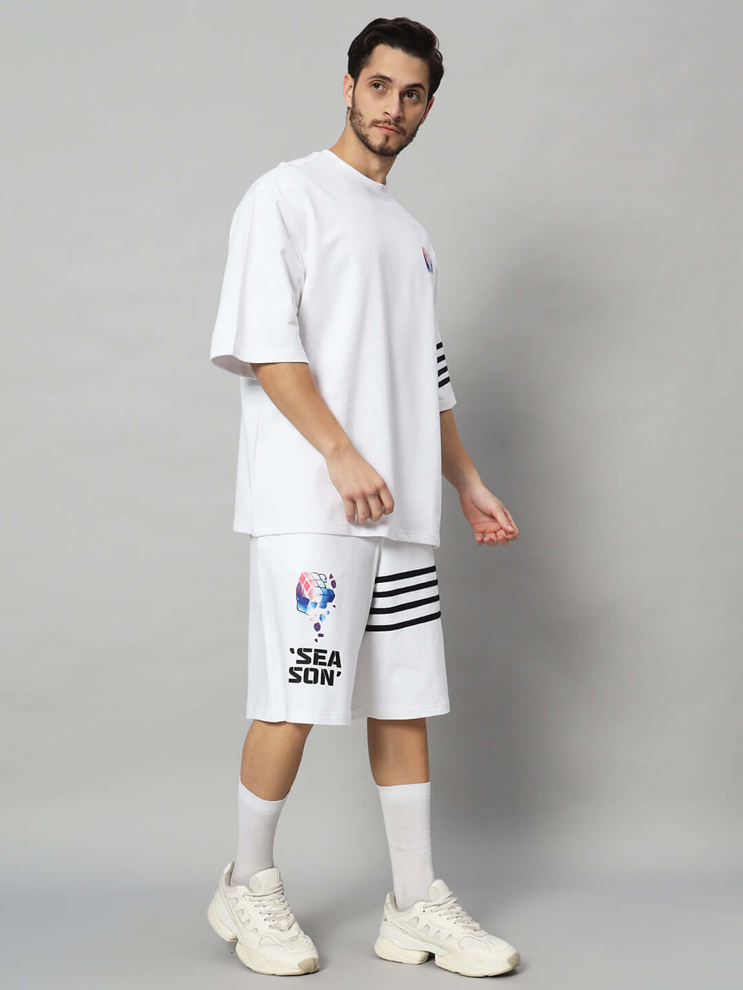 Man wearing SOUND SEASON white co-ord set featuring premium cotton French Terry, designed in India. Fashionable and comfortable.