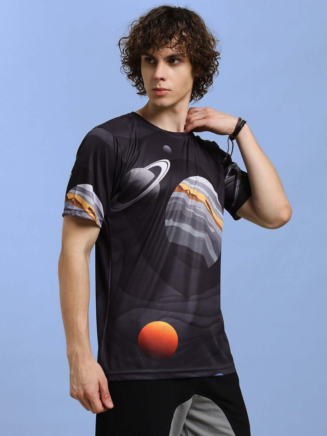 Model wearing black space fantasy printed t-shirt, showcasing planetary design on sports polyester fabric.