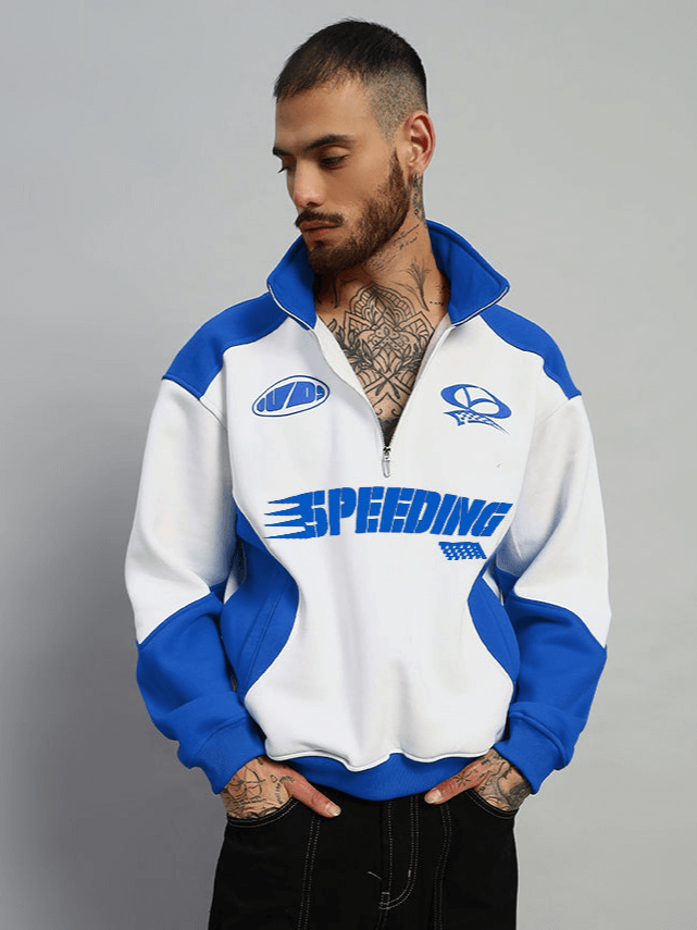Model wearing SPEEDING colorblock jacket in royal blue and white with bold design, showcasing custom fit option available from DUDS.