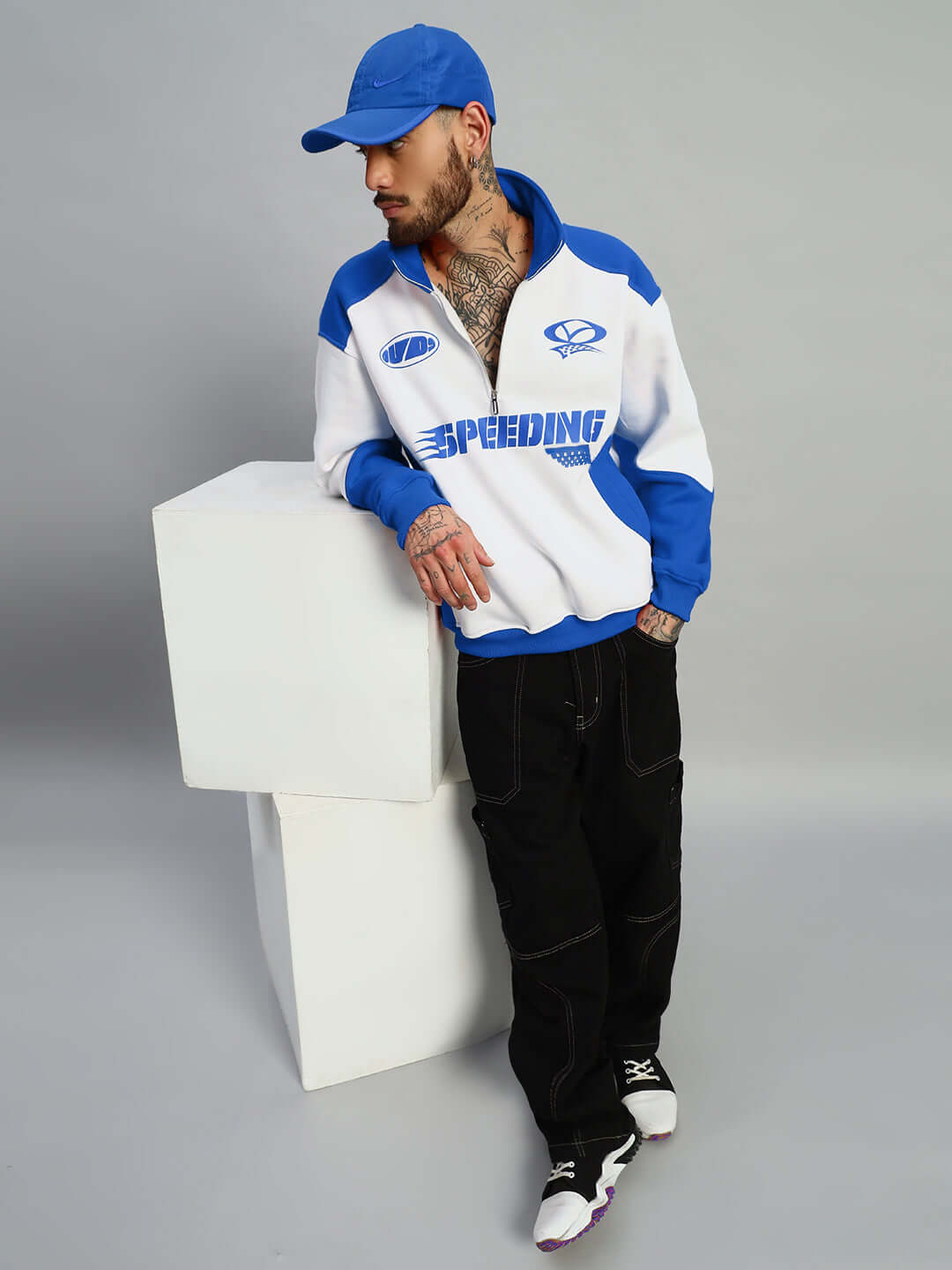 Model wearing SPEEDING colorblock jacket in royal blue and white, showcasing casual style.
