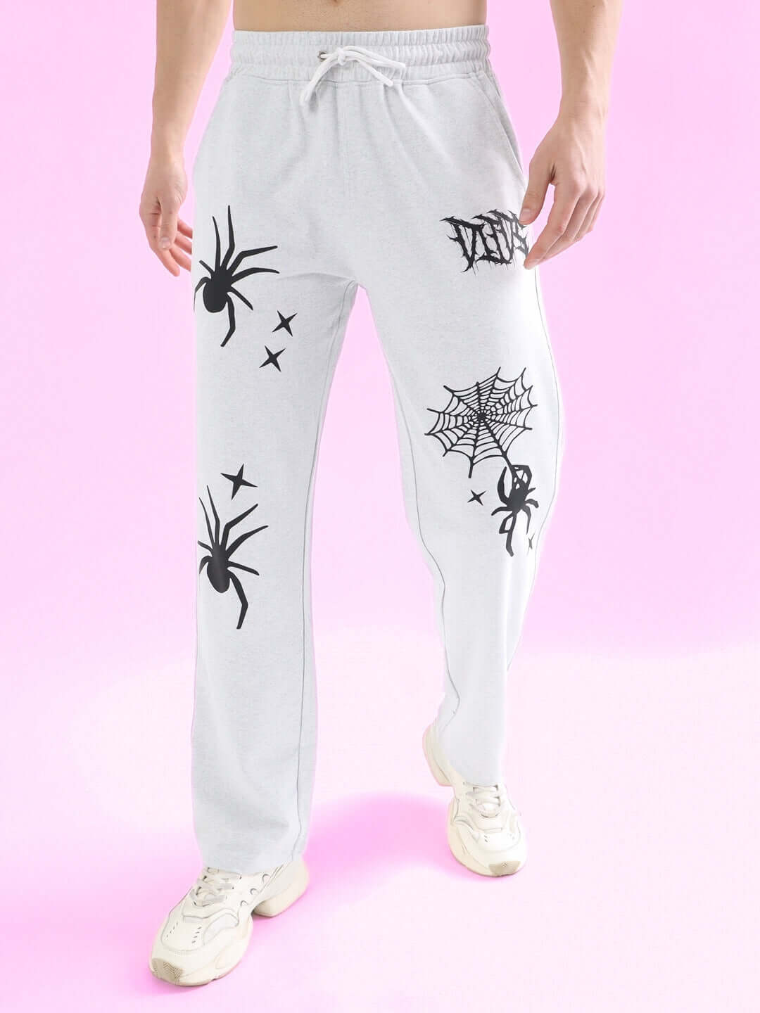 Light grey joggers with spider web design, featuring relaxed fit and custom size options, made by DUDS.