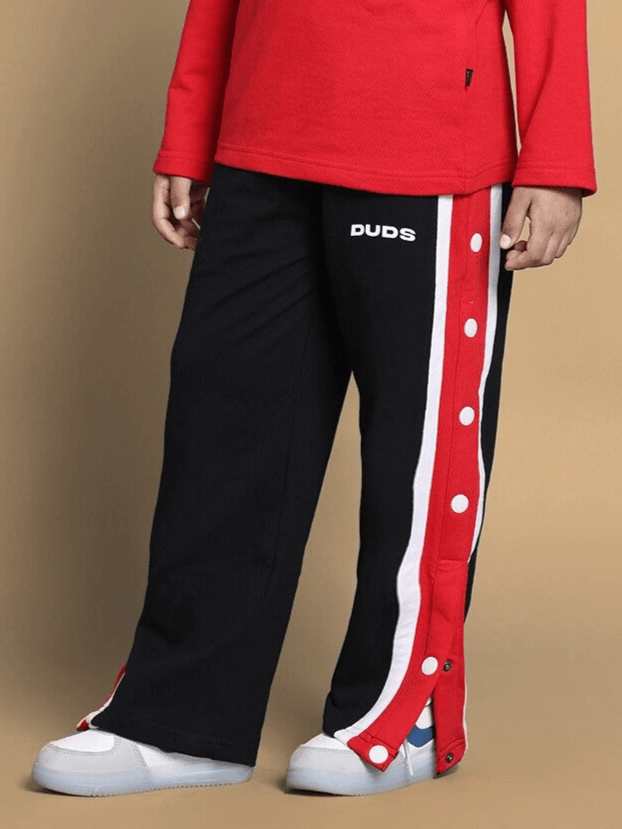 Child wearing SPIDERROBO co-ord set with red top and black snap button pants by DUDS.