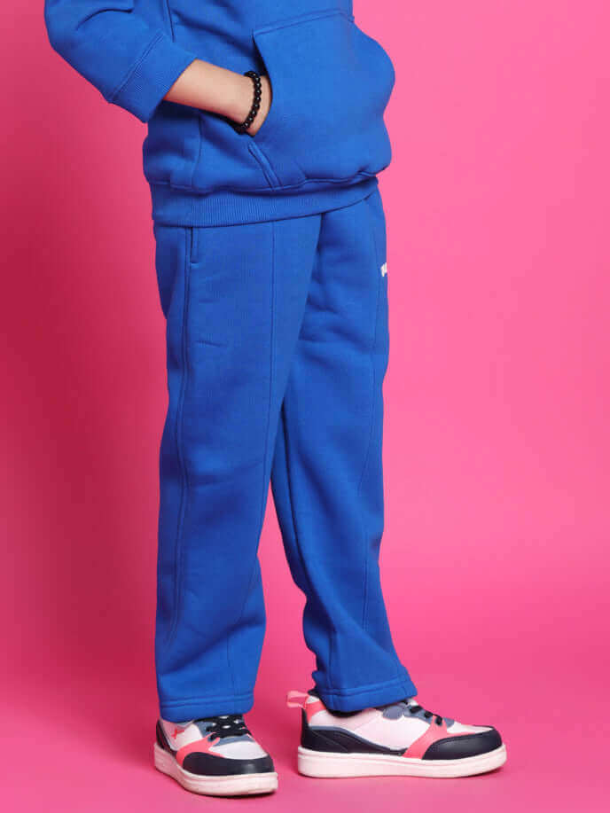 Child wearing SPIDERROBO oversized blue hoodie and pants against pink background