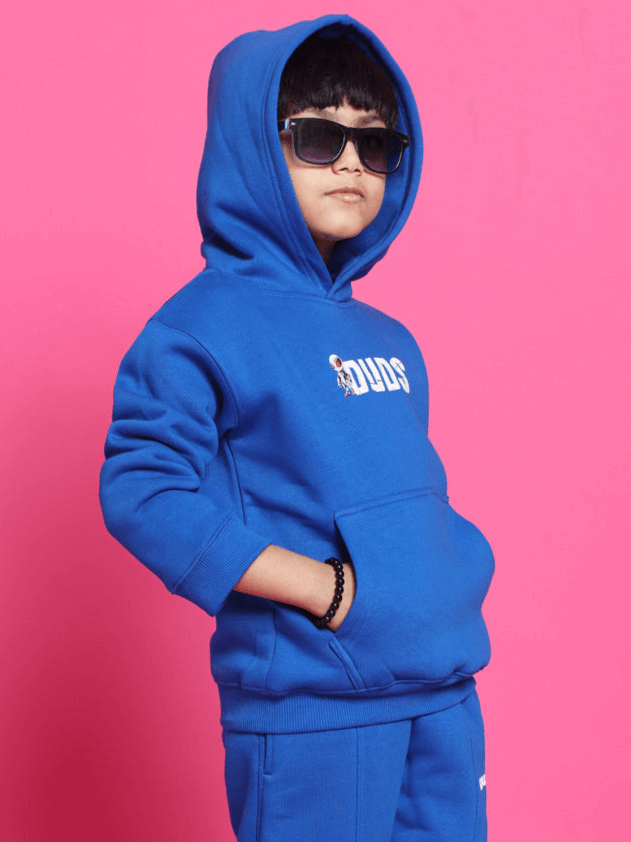 Child wearing a blue SPIDERROBO oversized hoodie by DUDS, posing confidently in sunglasses. Customizable fit available.