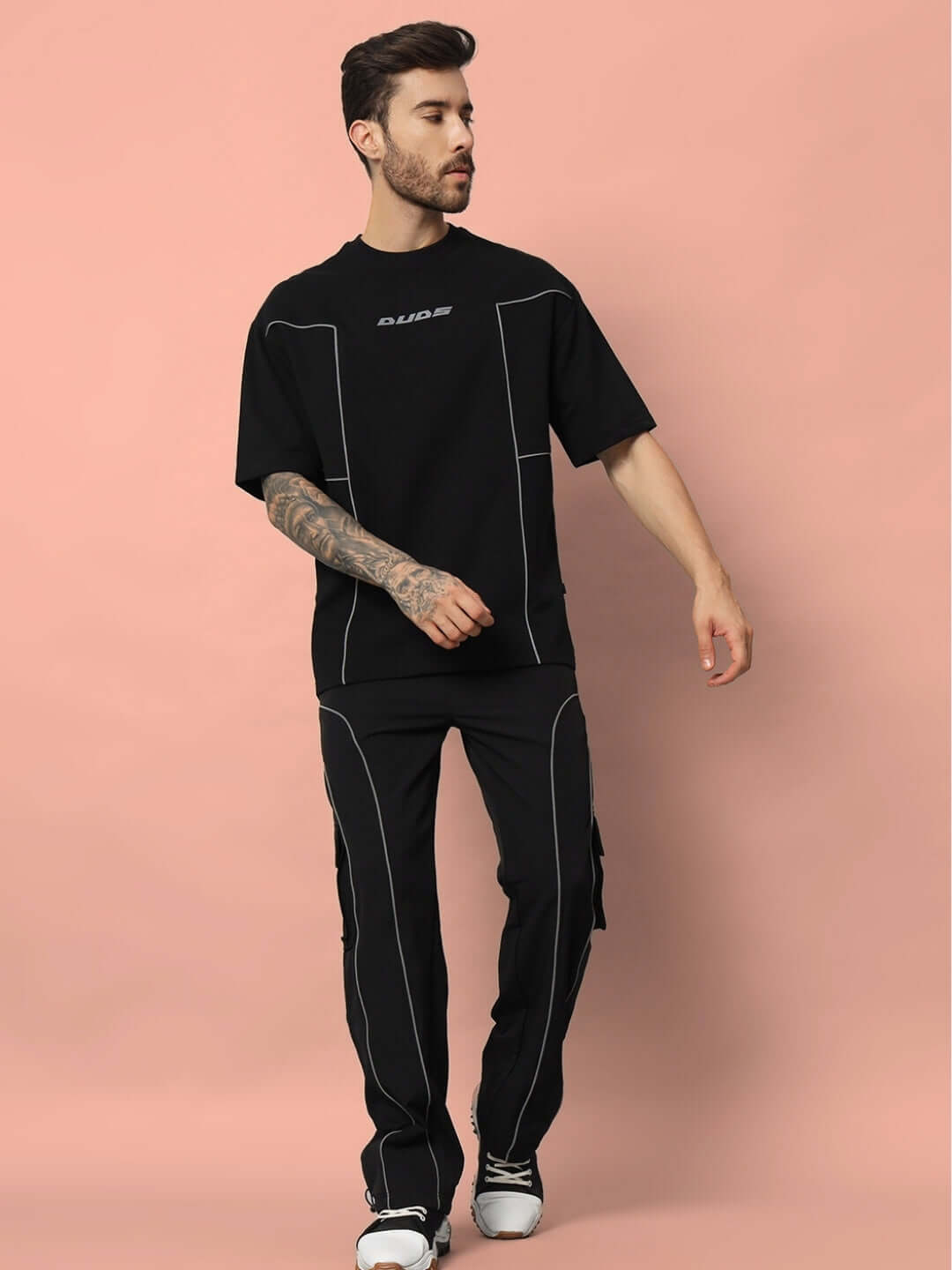 Model wearing Spinal Faux Reflector Over-Sized T-shirt in black, made of premium cotton French terry and elastane, showcasing casual style.