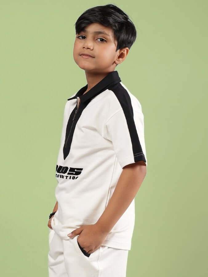 Young boy wearing SPLINTER T-SHIRT FOR BOYS & GIRLS OFF WHITE on a green background