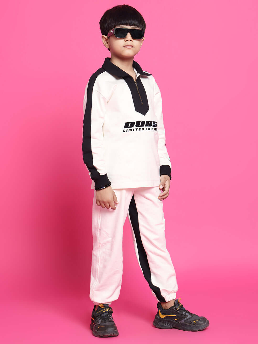 SPLINTER OVERSIZED CO-ORD SET FOR BOYS GIRLS OFF WHITE BLACK on child model against pink backdrop