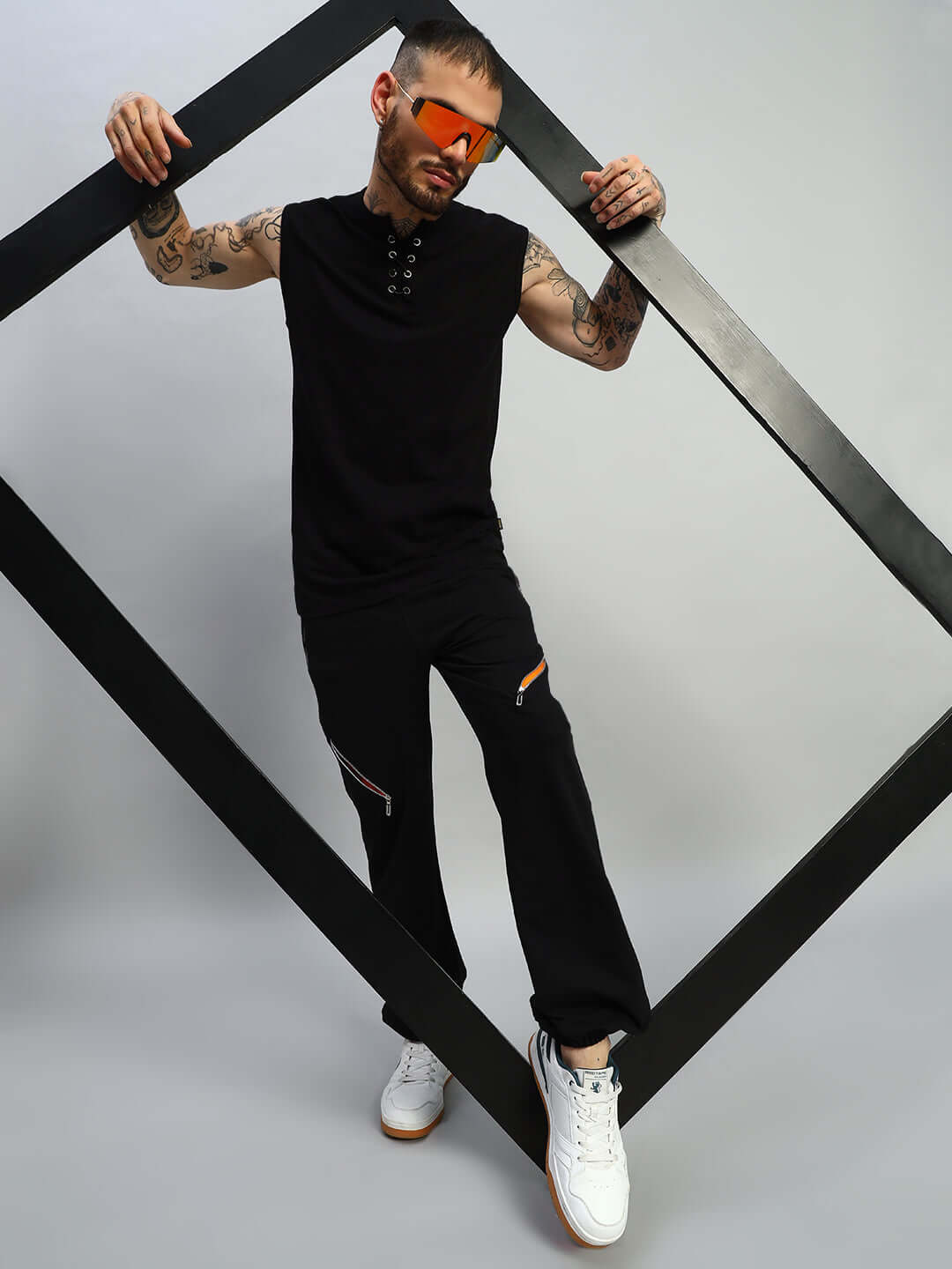 Model wearing SQUALL JOGGERS (BLACK) by DUDS, showcasing custom fit joggers paired with casual sneakers, styled for modern fashion.