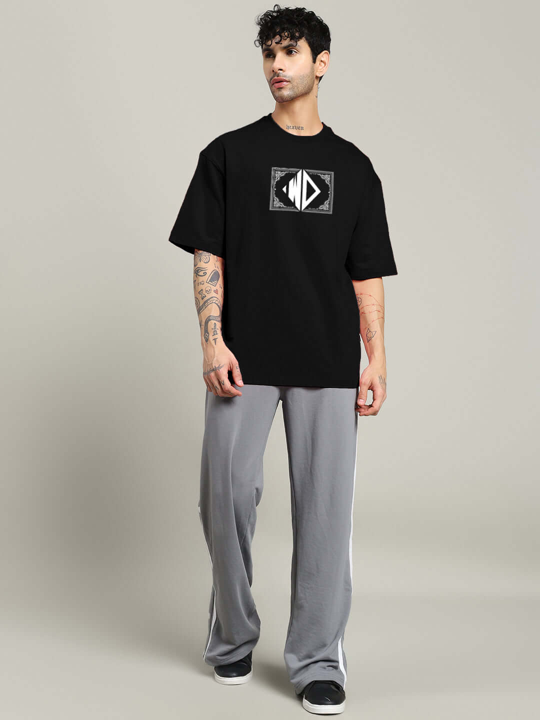 Model wearing square frame oversized black t-shirt made from premium heavy gauge fabric, featuring bio-washed cotton and elastane blend.