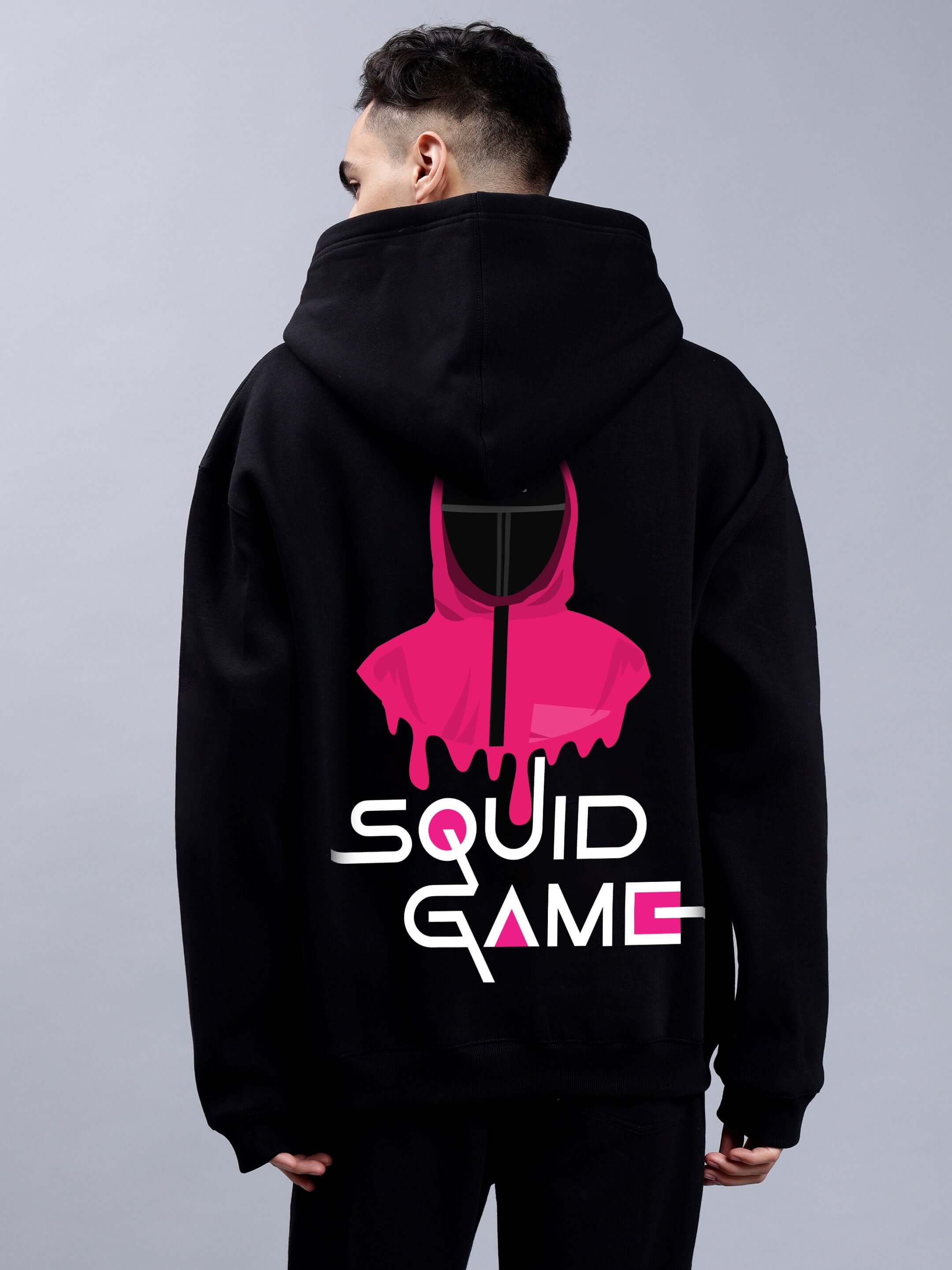 Man wearing Squid Game Oversized Hoodie Men Black with pink design on back