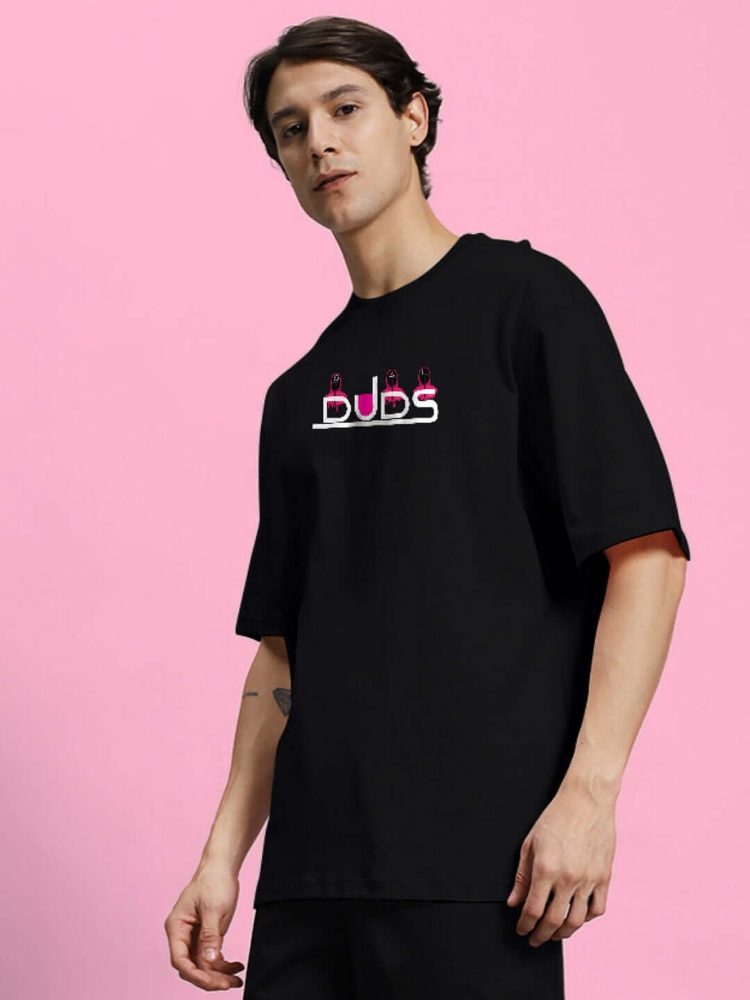Male model wearing SQUID GAME PRINTED OVERSIZED T-SHIRT BLACK made of 100% cotton with premium heavy gauge fabric.