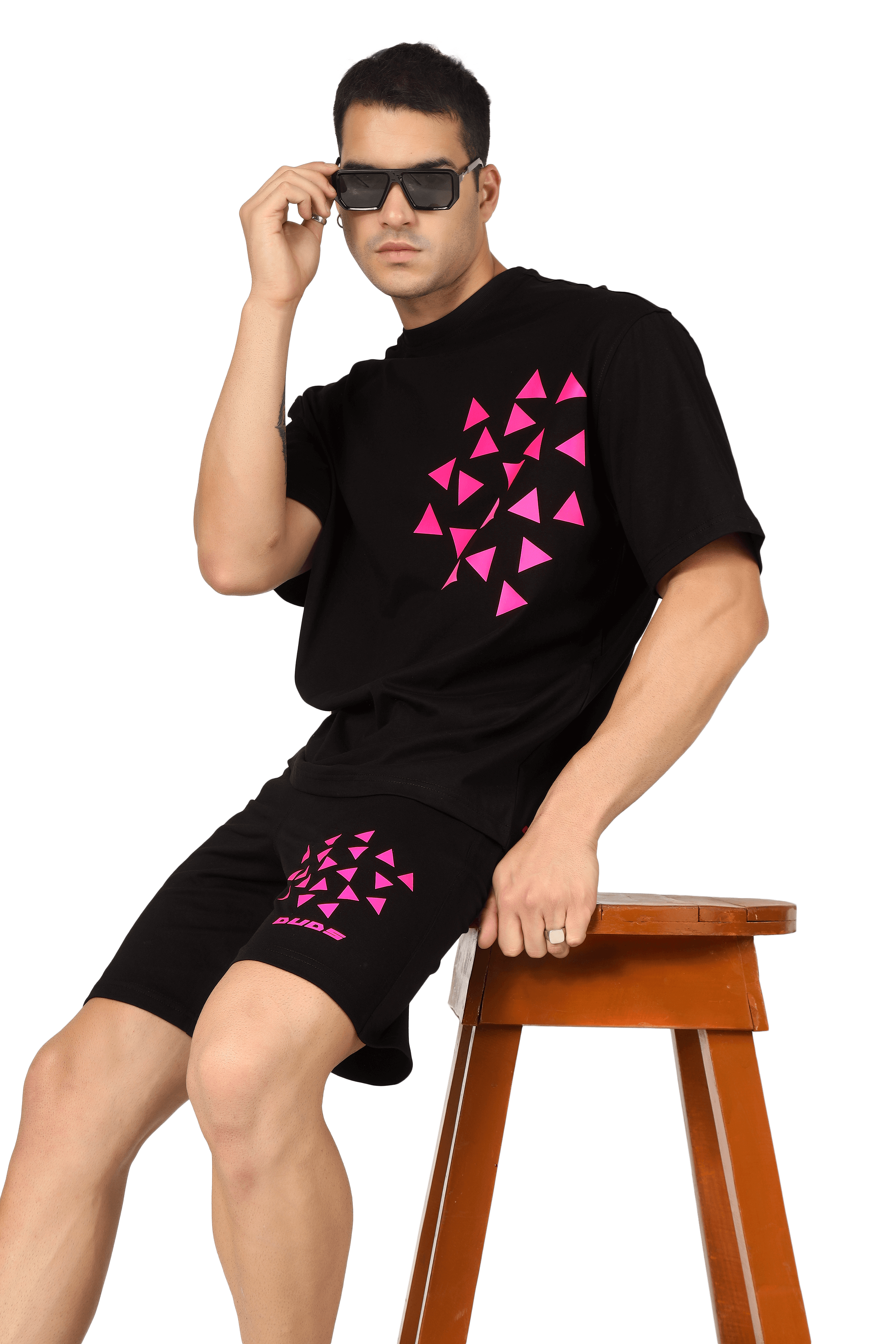 Model wearing Star Dust print co-ord set with customized fit options, available for prepaid orders, seated on a wooden stool.