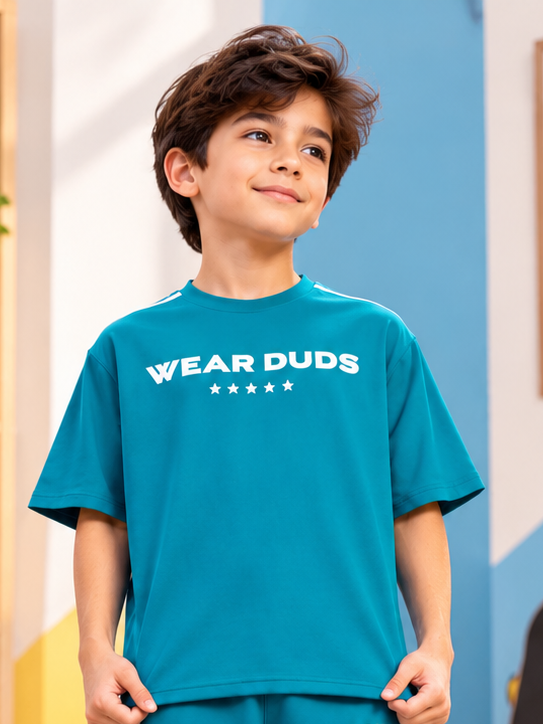 STAR JUMPER OVER-SIZED T-SHIRT FOR BOYS GIRLS TEAL worn by smiling boy, casual kids fashion