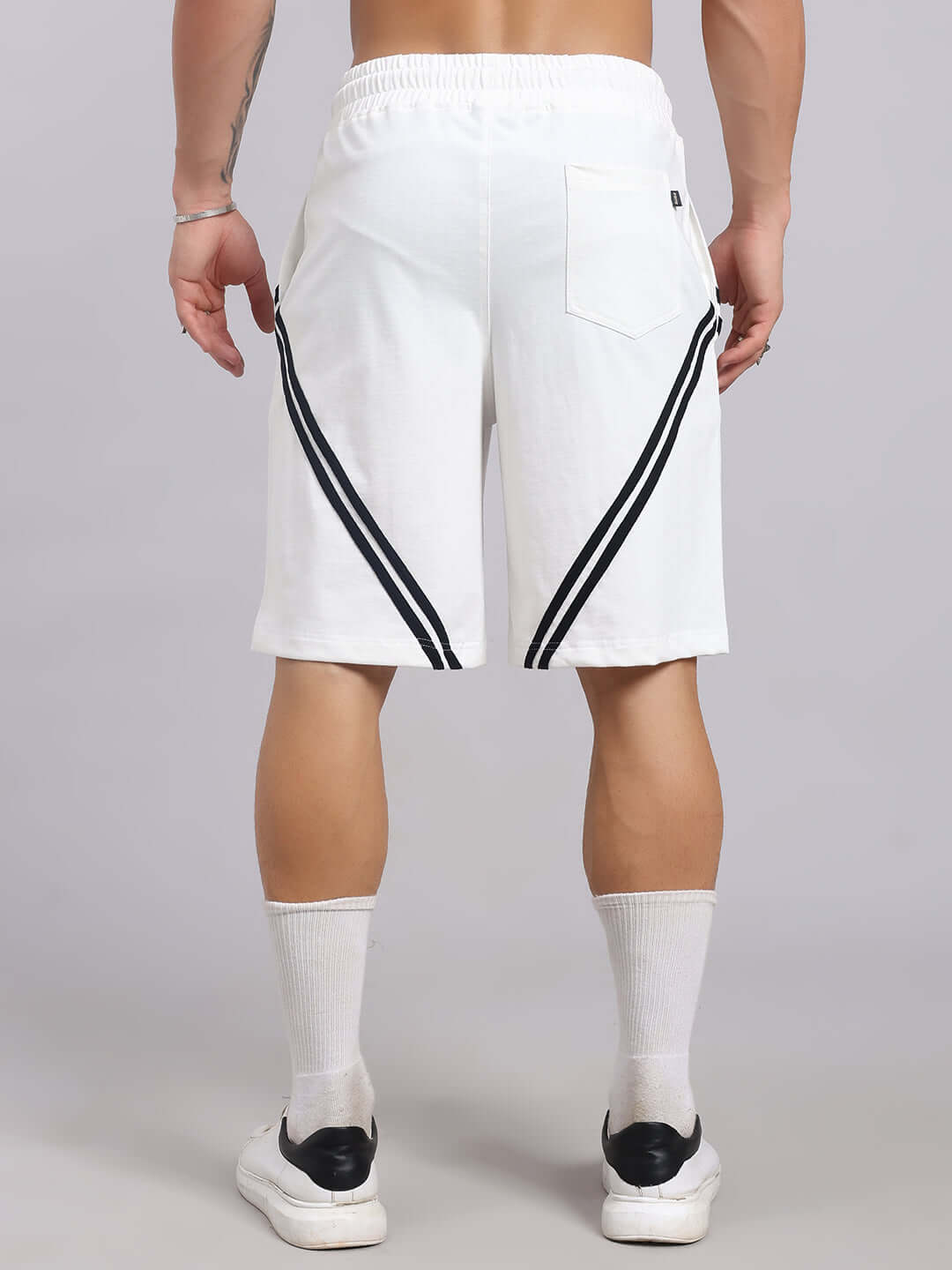 Back view of STAR JUMPER REGULAR FIT SHORTS OFF WHITE with black stripes, worn by a male model.