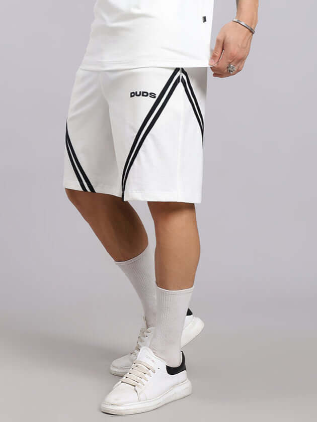 Person wearing STAR JUMPER REGULAR FIT SHORTS OFF WHITE with star design, showcasing casual style.