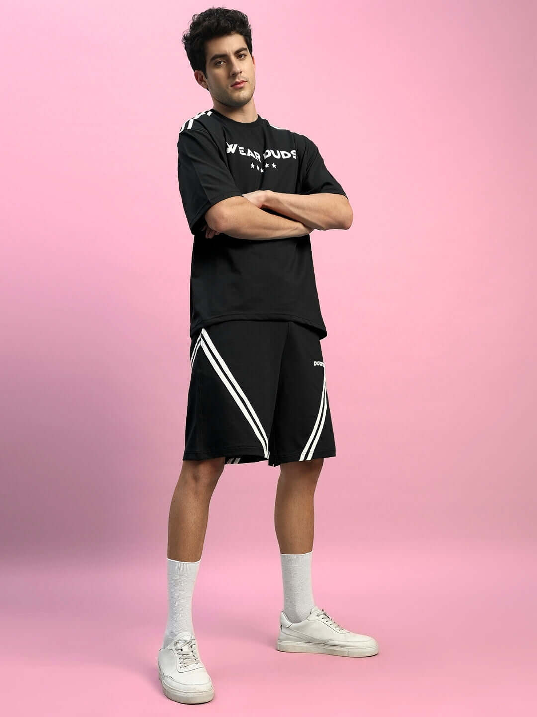Model wearing STAR JUMPER SUMMER CO-ORD SET BLACK against pink background