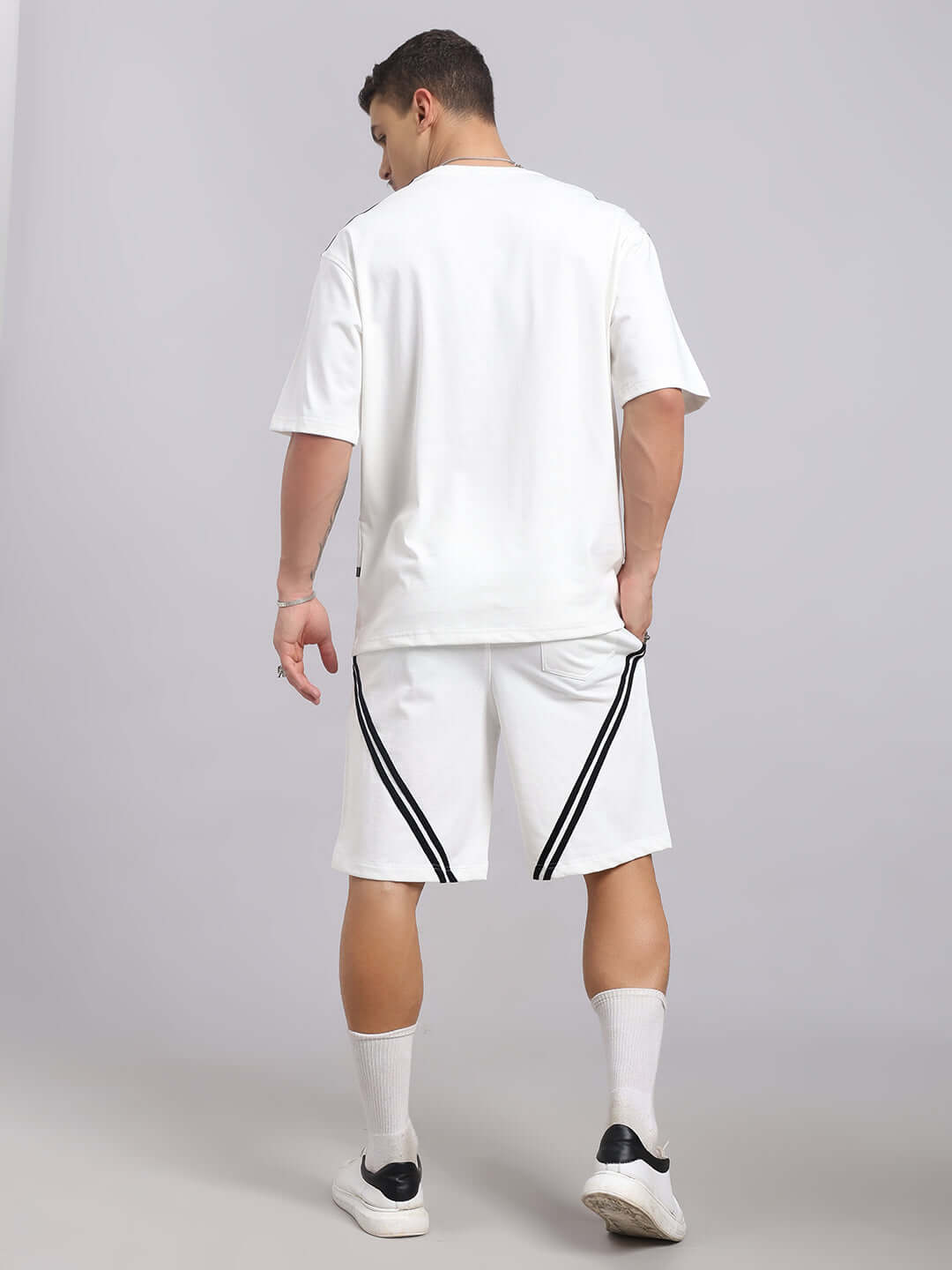 Back view of model wearing STAR JUMPER SUMMER CO-ORD SET in off white, featuring premium cotton and elastane blend shorts and top with stripes.