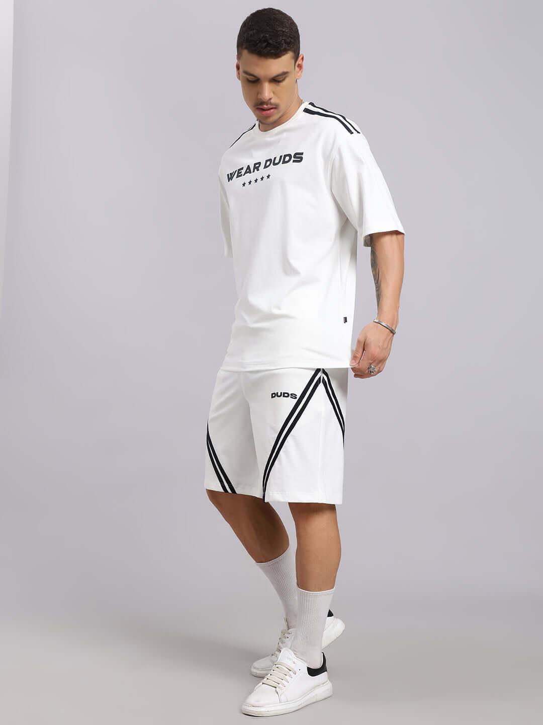 Model wearing STAR JUMPER SUMMER CO-ORD SET in off white, featuring premium cotton French terry with black accents, perfect for summer fashion.