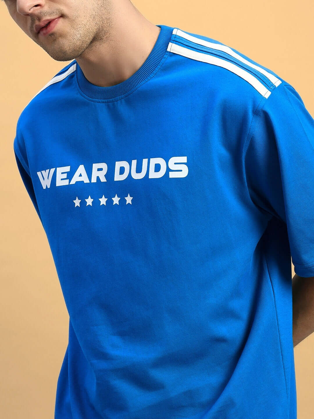 Man wearing STAR JUMPER SUMMER CO-ORD SET ROYAL BLUE oversized t-shirt with trendy design.